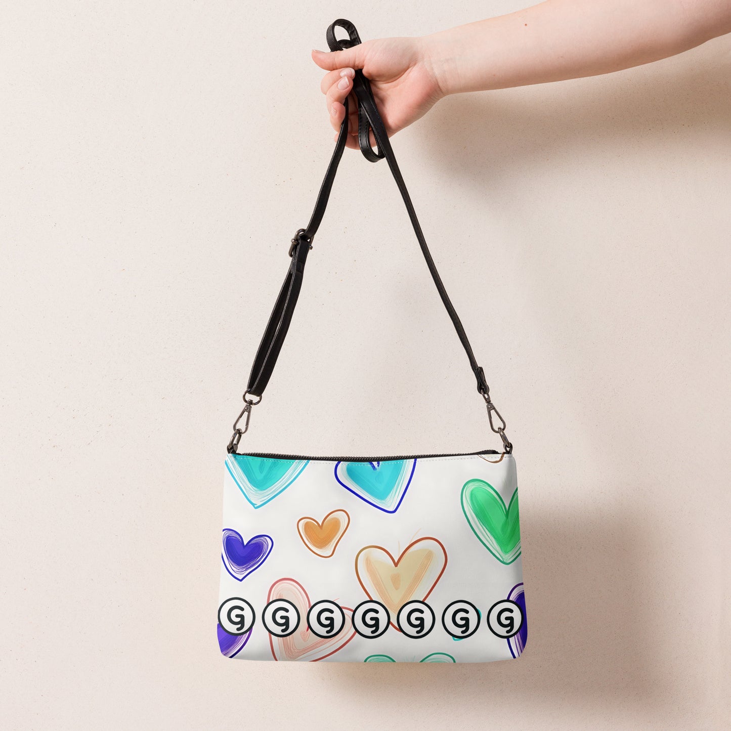 Back of crossbody bag with hearts on white background and Girly logos