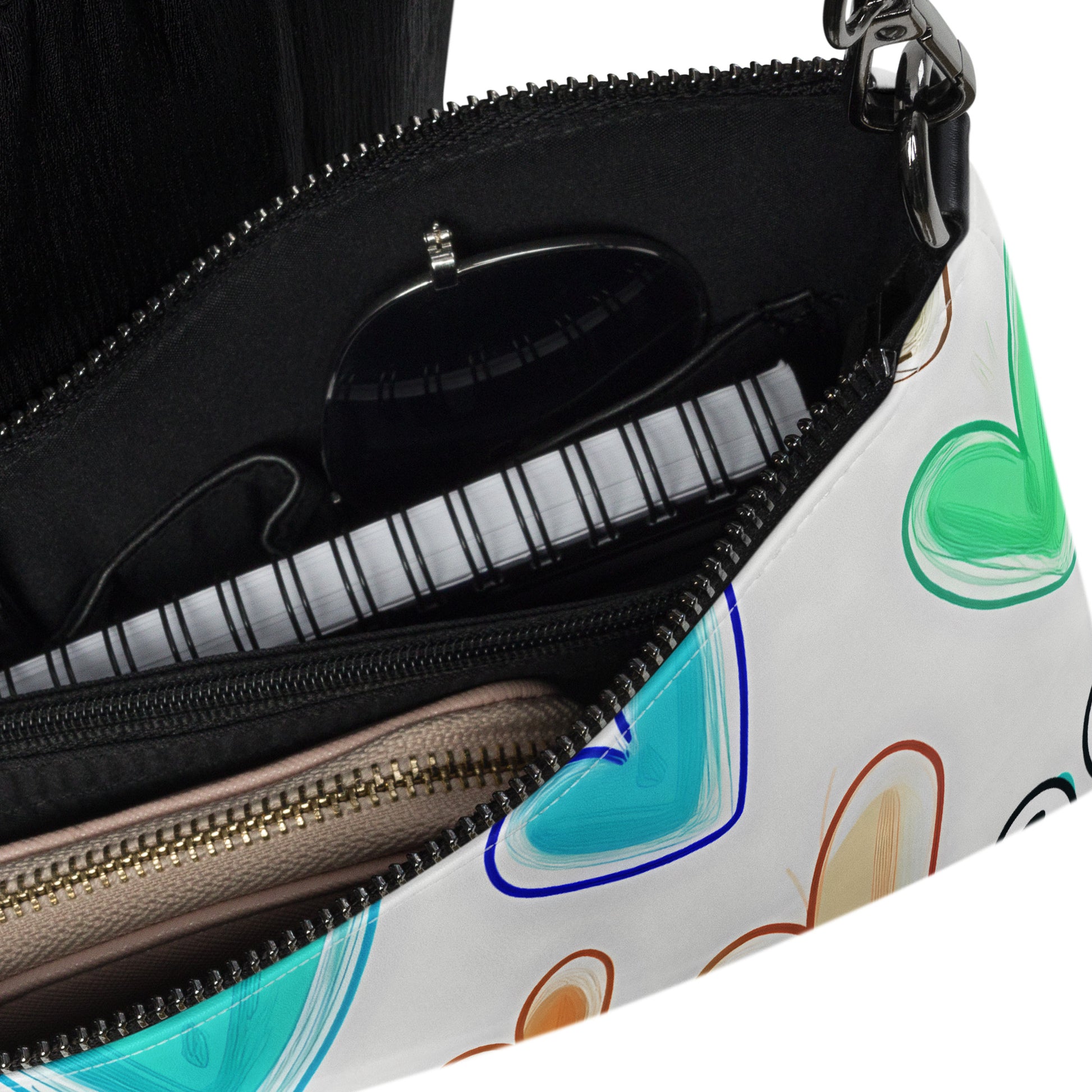 Inside of crossbody bag with hearts on white background