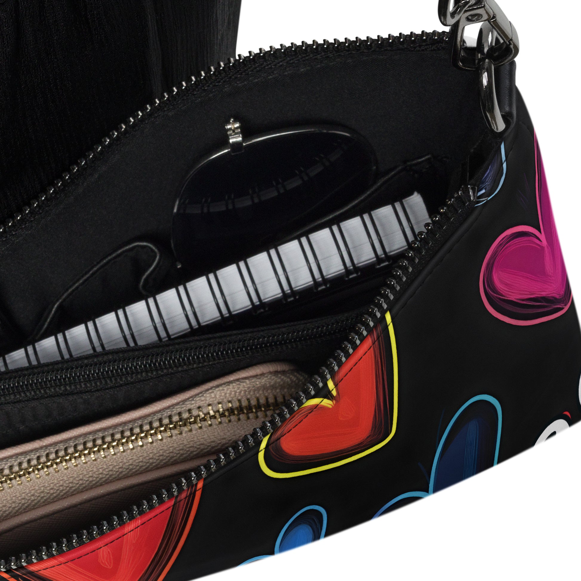 Inside of crossbody bag with hearts on black background