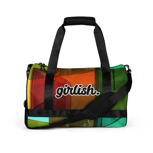 Front of gym bag with on square pattern of brown, red, green, and gold background and word saying 'girlish'