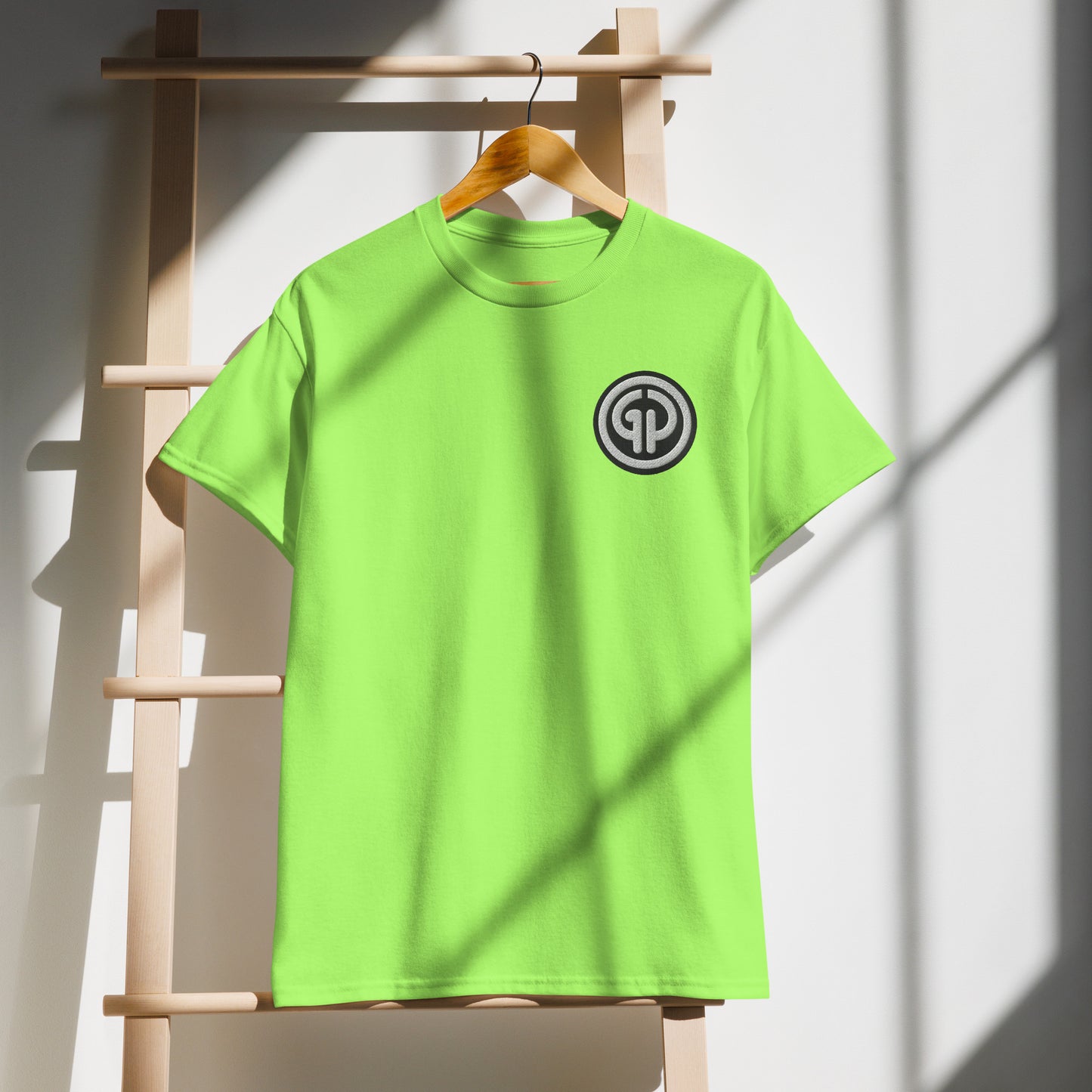 Front of hanging lime t-shirt with God's Property 'GP' emblem embroidered on left chest
