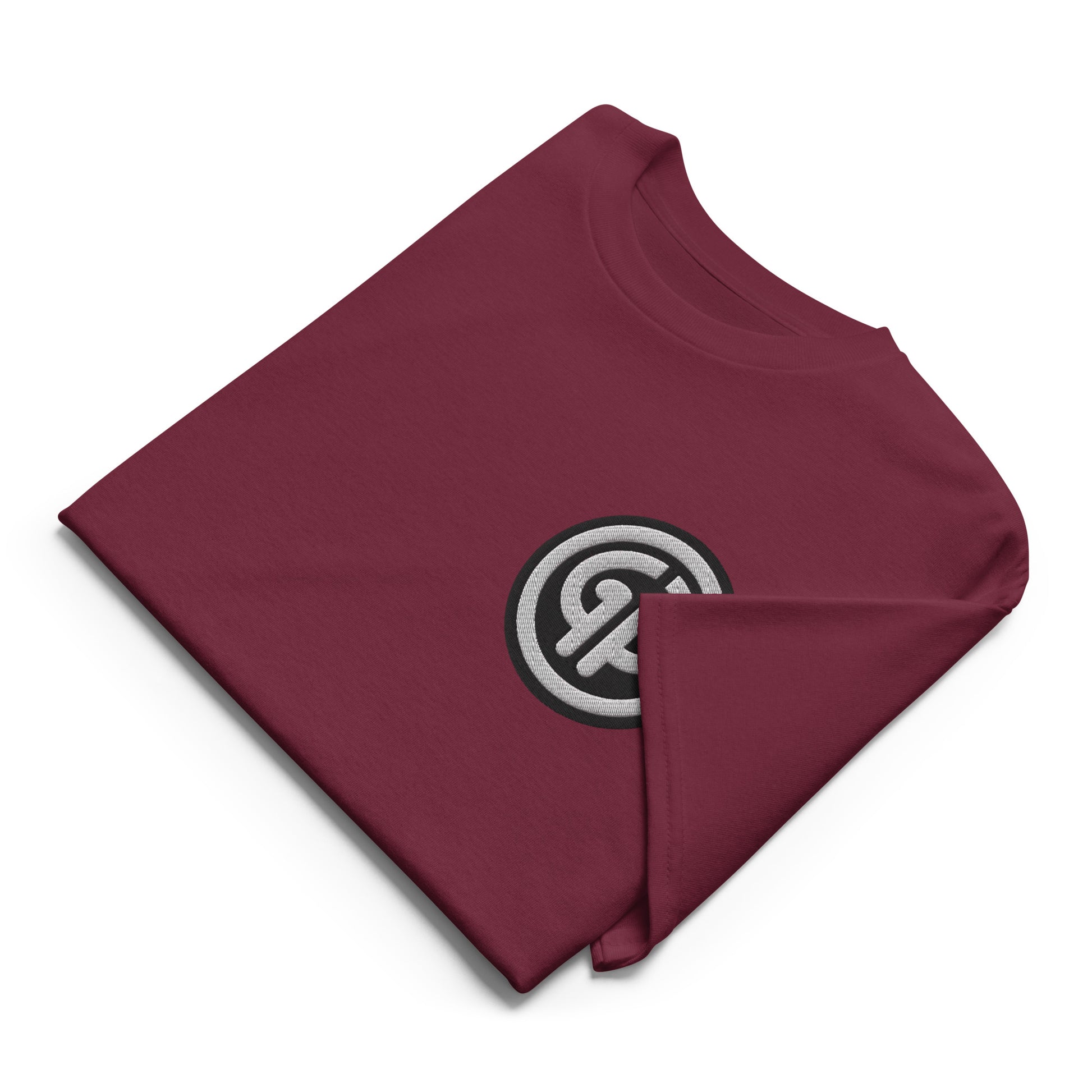 Front of folded maroon t-shirt with God's Property 'GP' emblem embroidered on left chest