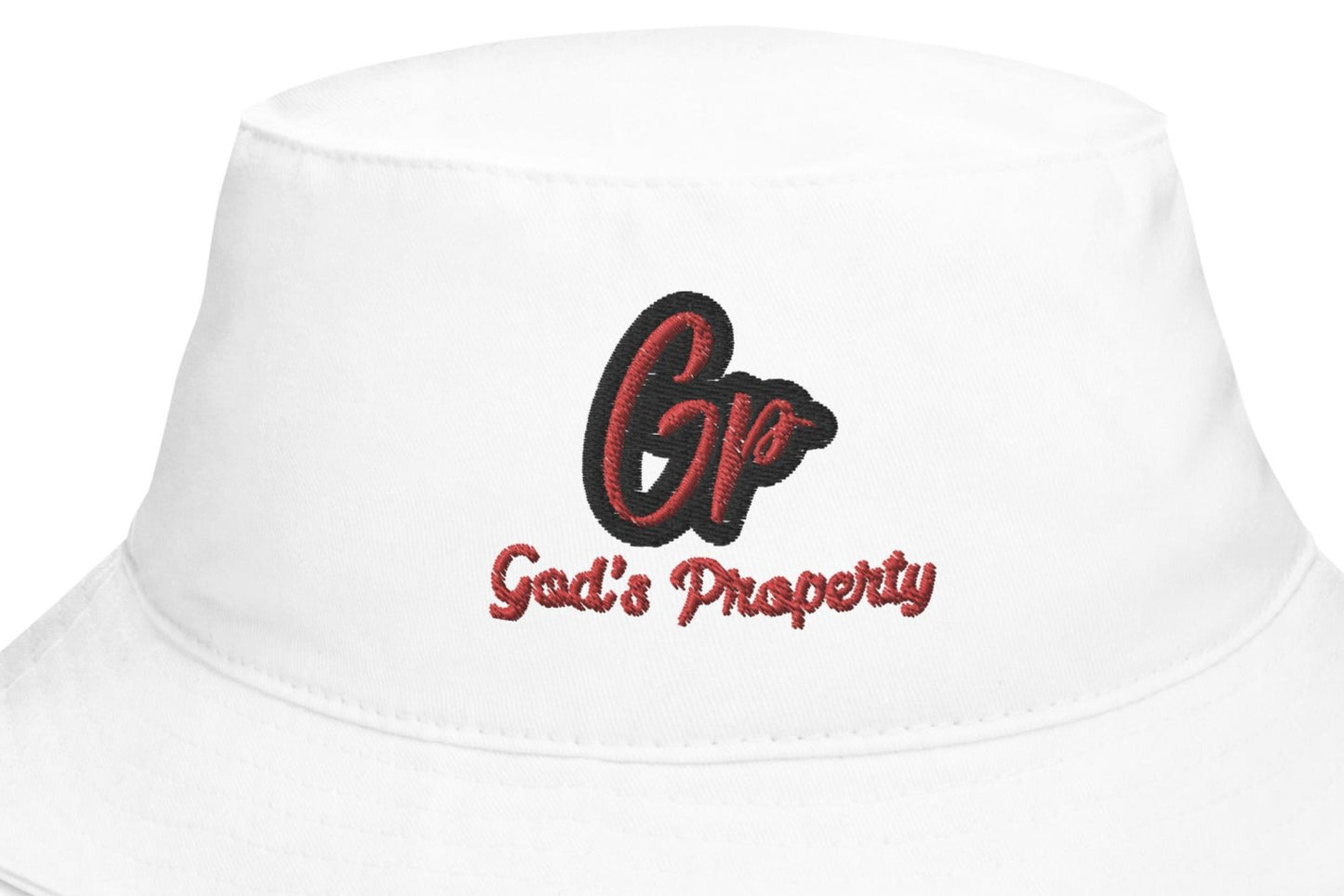 Front zoomed of white embroidered hat with red and black text saying 'GP, God's Property'