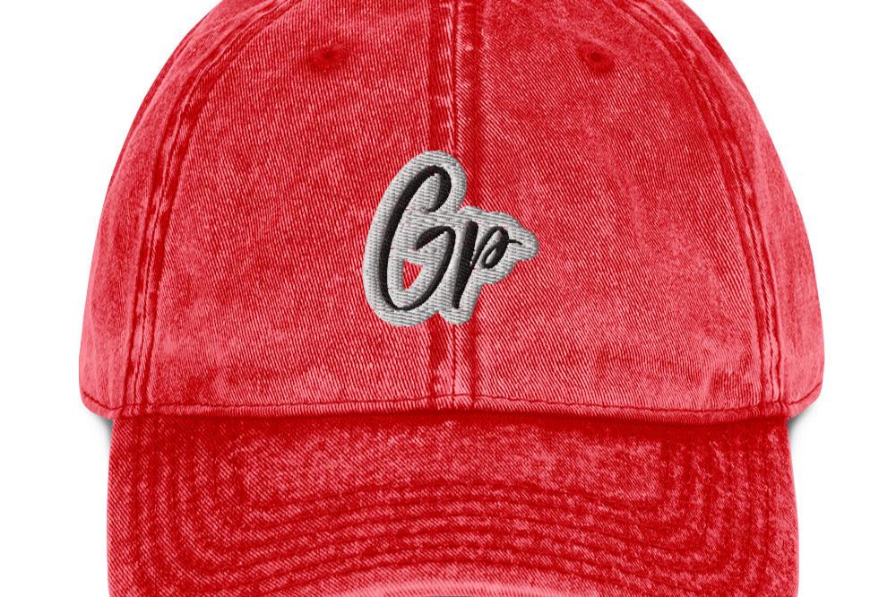 Front of red unisex twill cap with embroidered of 'GP'