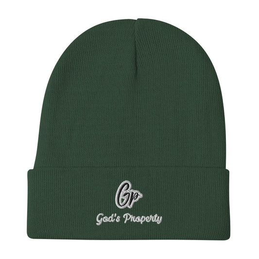 Front of dark green knit beanie embroidered with black and gray text saying 'GP, God's property