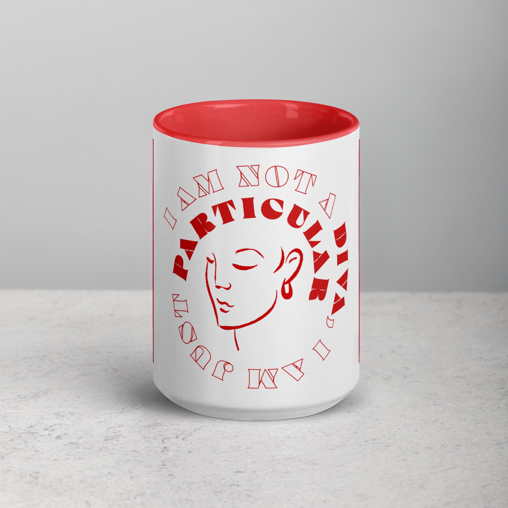 Front view of white mug with red inside and an outline of woman's face circled by text saying 'I am not a Diva, I am just particular, all in red