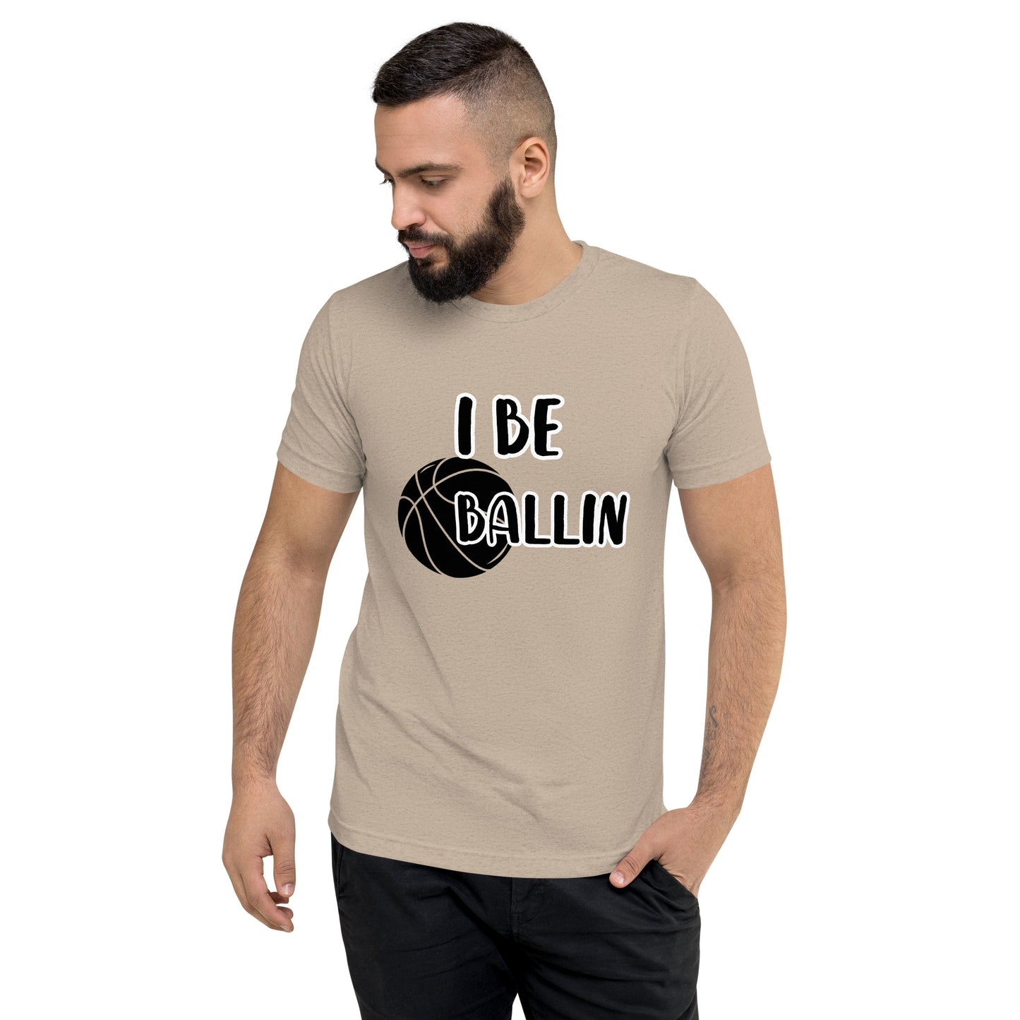 Front of tan t-shirt with image of black basket and black and white text saying 'I Be Ballin'