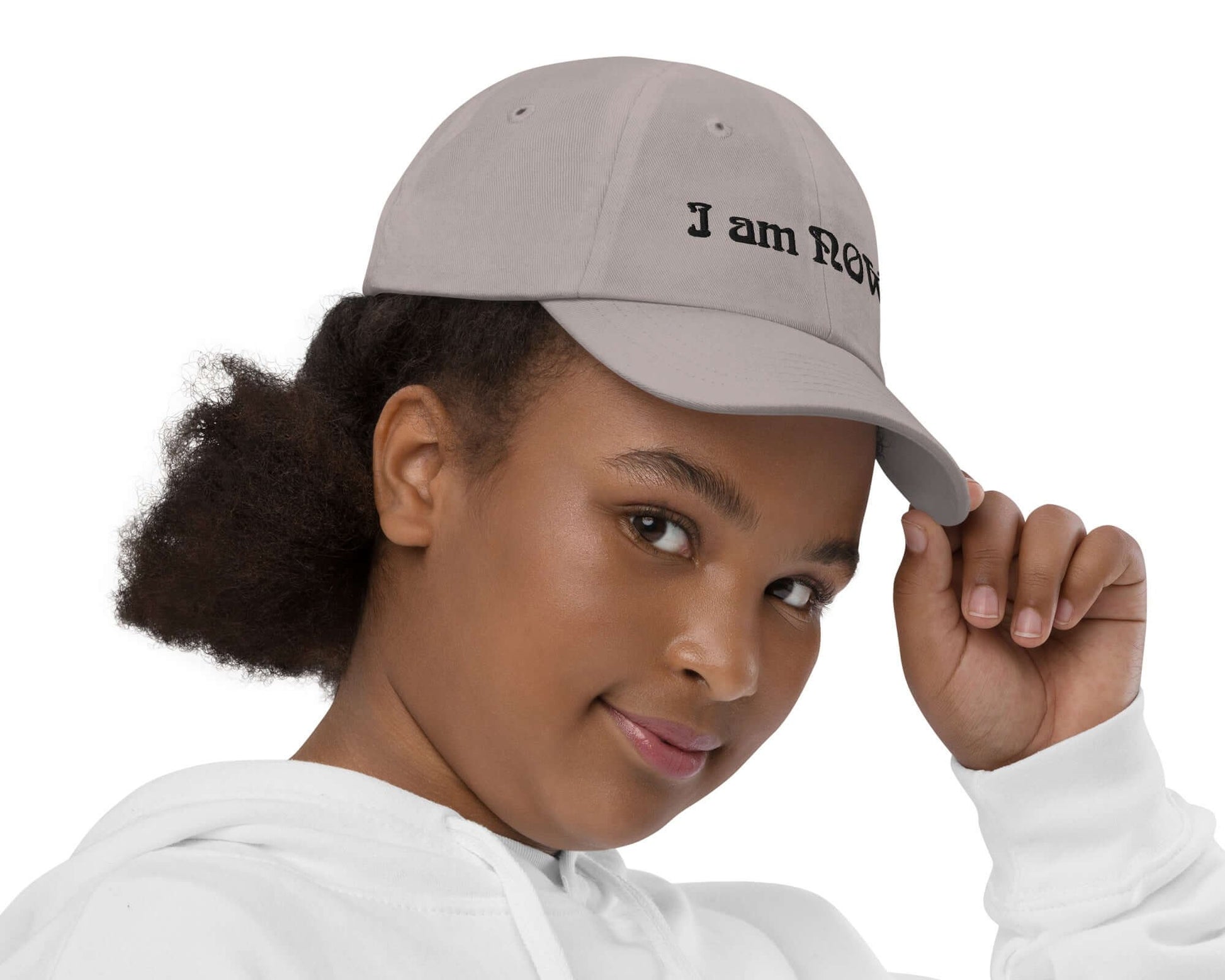 Right view of youth wearing a grey baseball cap with text saying 'I am now' across the front