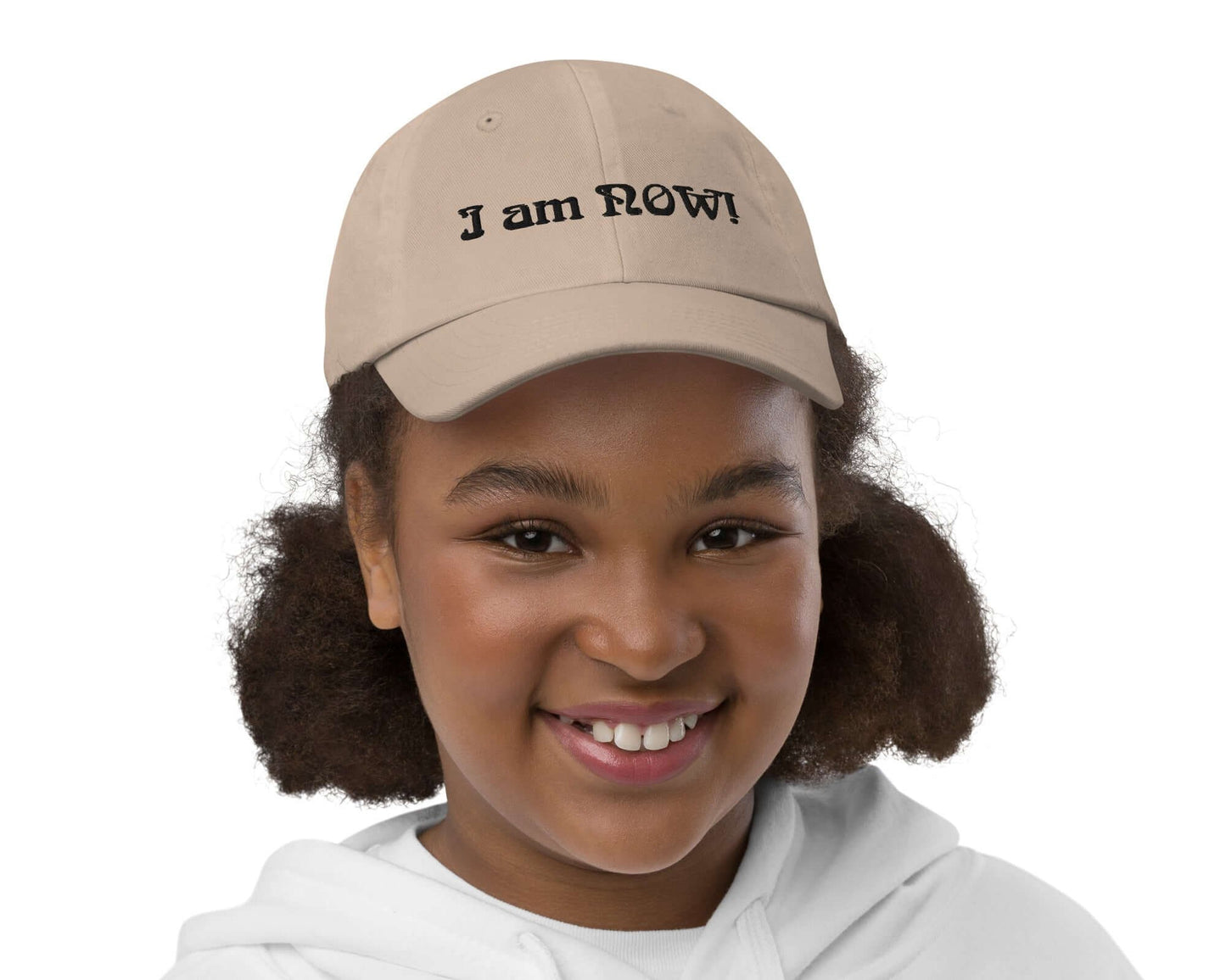 Front view of youth wearing a khaki baseball cap with text saying 'I am now' across the front