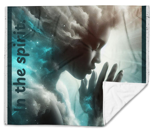 Front of blue, white and gray 50x60 throw blanket with image of woman praying and text saying 'in the spirit'