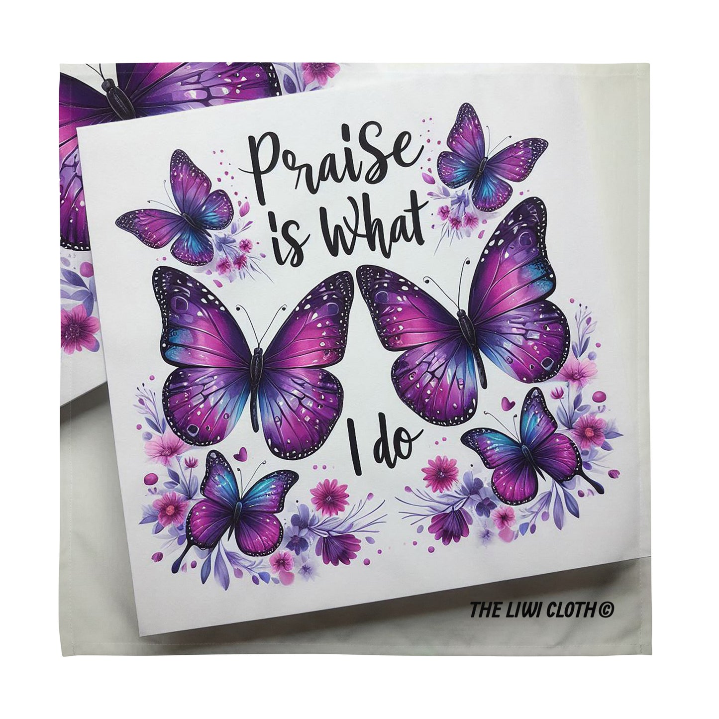 Front of LIWI cloth with purple butterflies and black text saying 'praise is what I do' on a white background