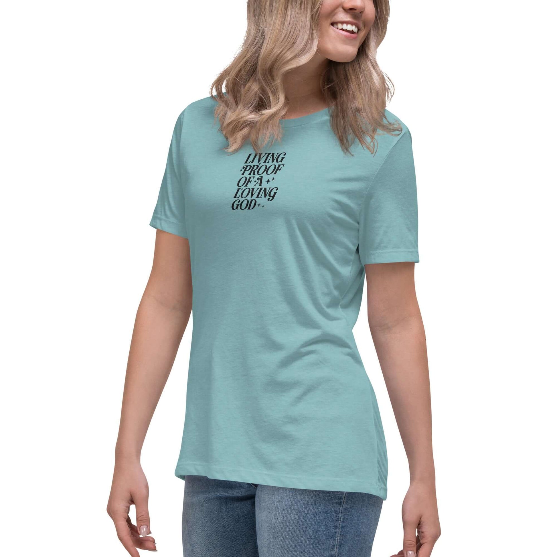 Left front of blue lagoon t-shirt with embroidered text saying 'living proof of a loving God'