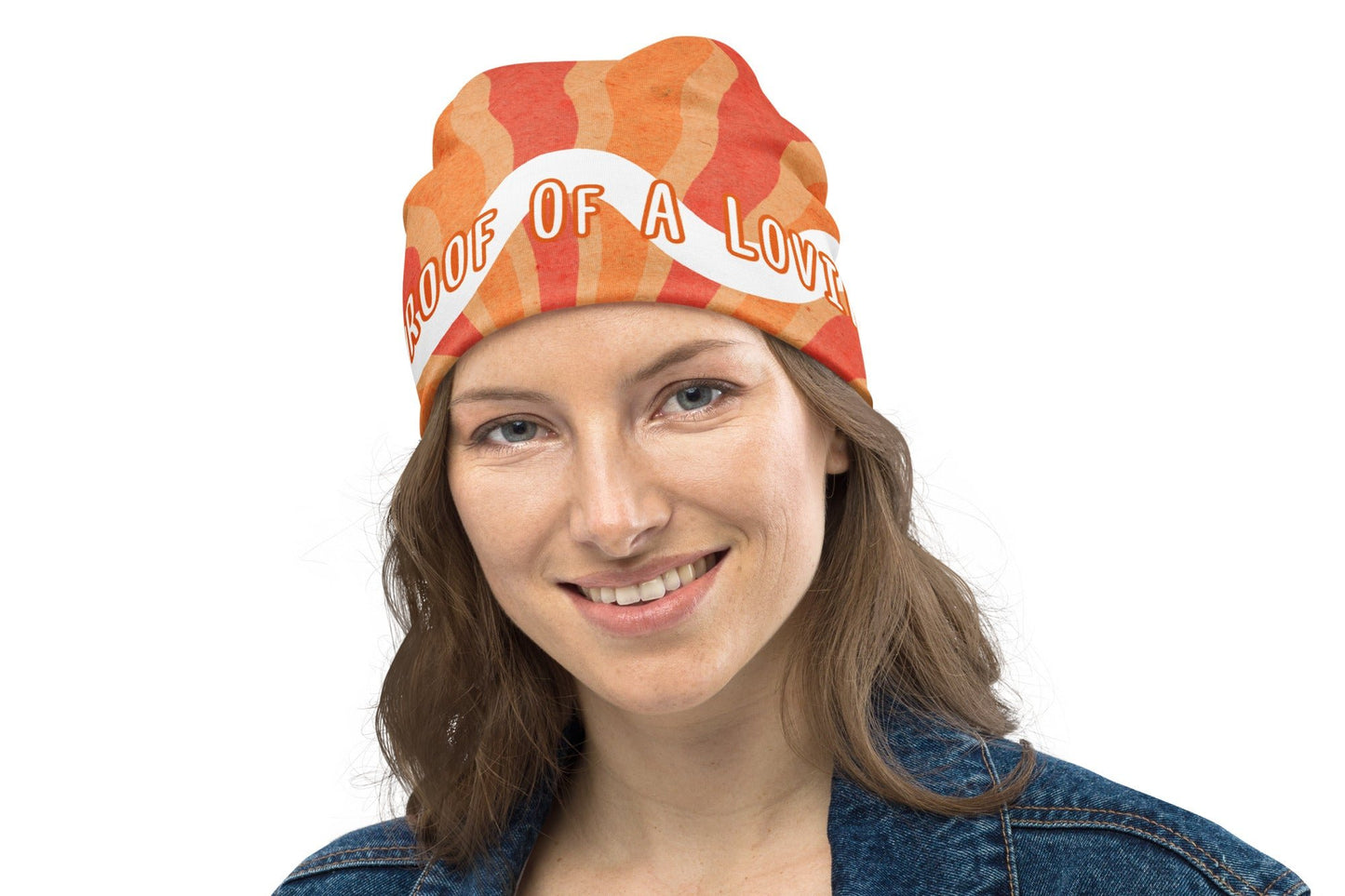 Front of orange and white beanie with text saying 'Living proof of a loving God'