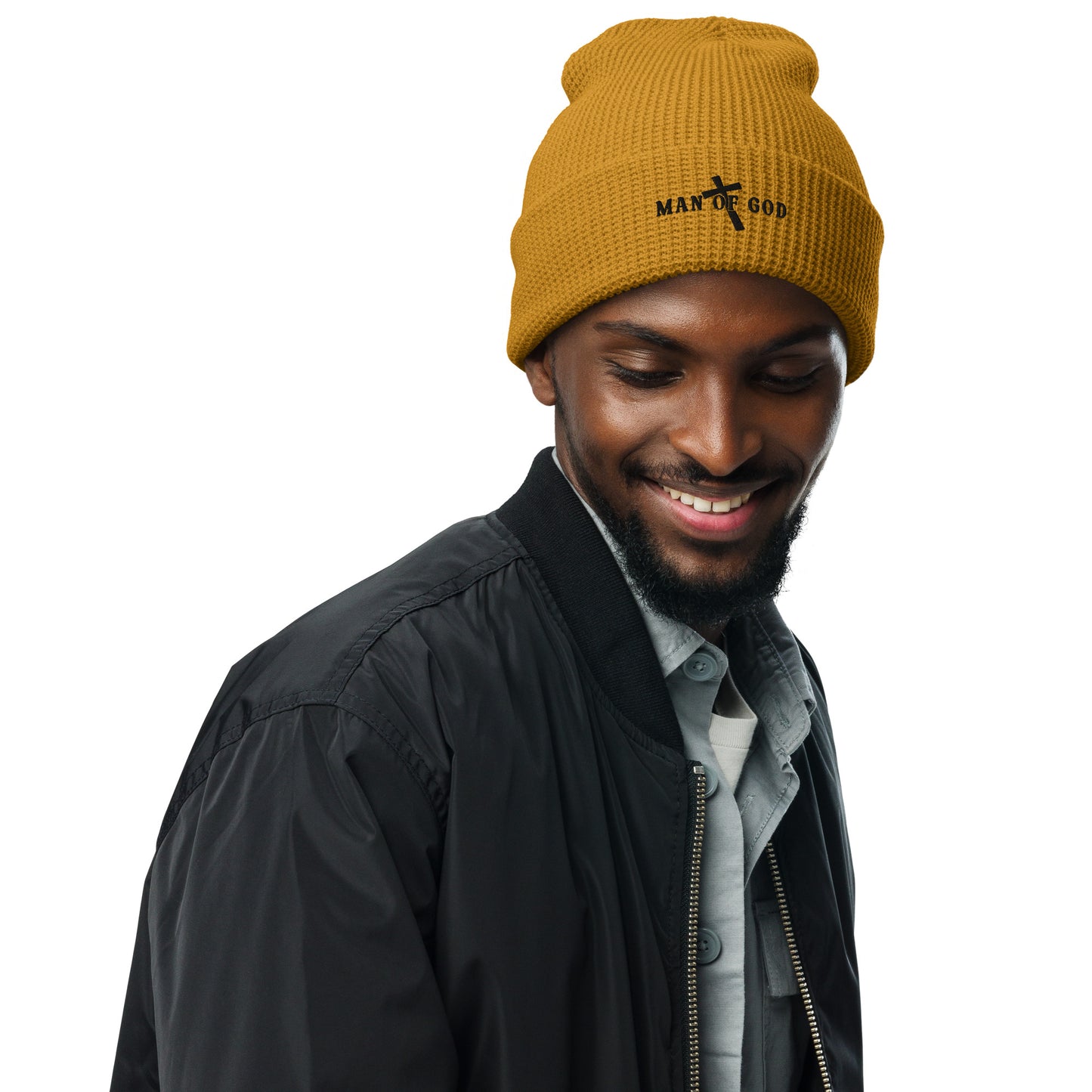 Front of camel waffle beanie with embroidered black symbol of Man of God and cross