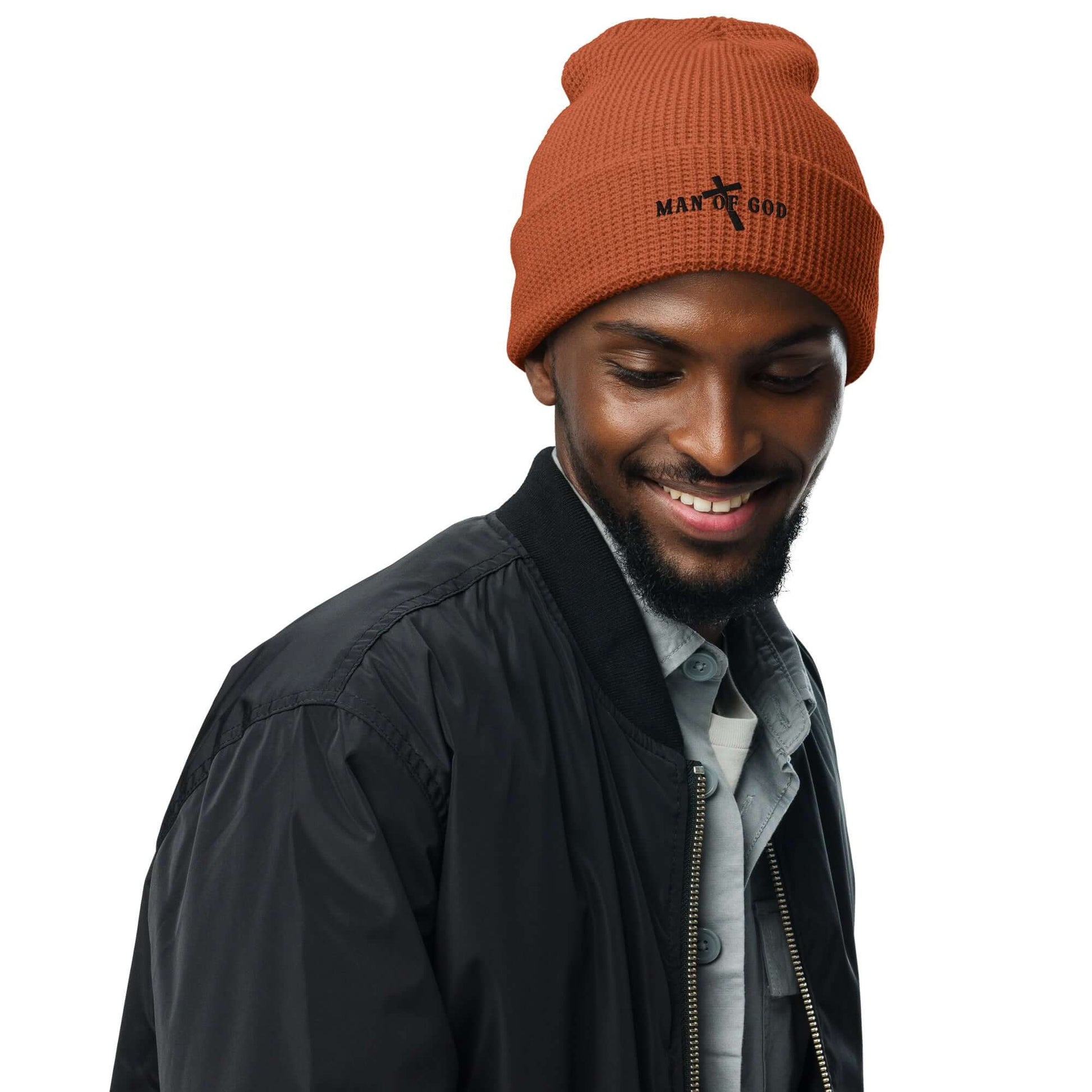 Front of rust waffle beanie with embroidered black symbol of Man of God and cross