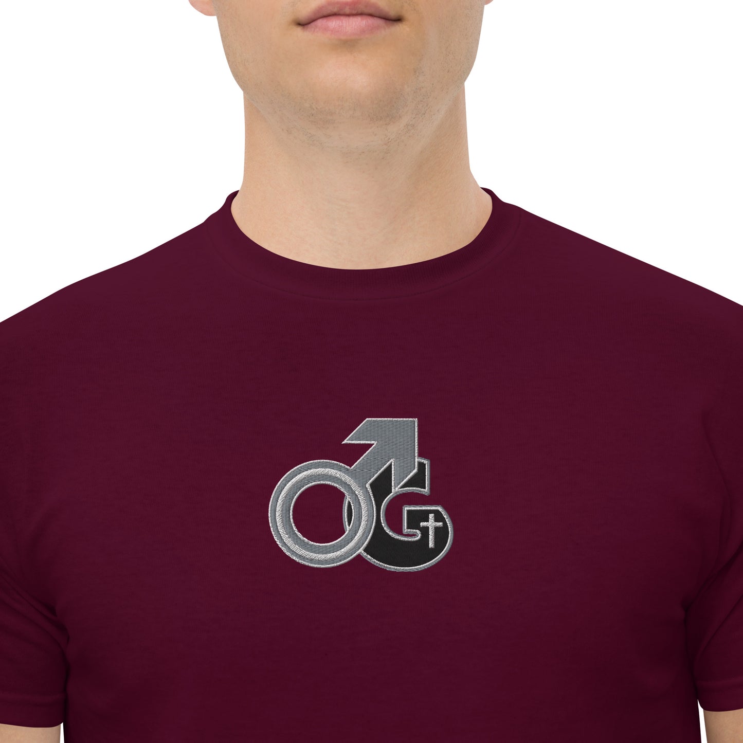 Front of maroon t-shirt with black, gray and white embroidered symbol representing Man of God