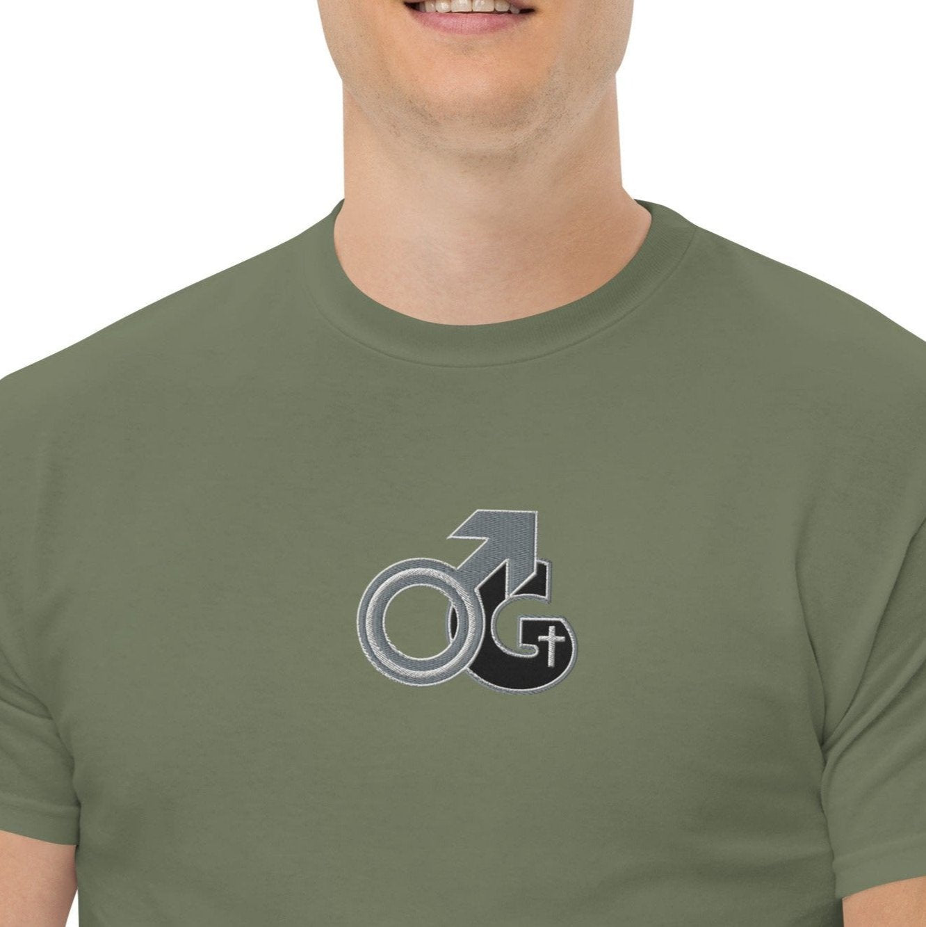 Front of military green t-shirt with black, gray and white embroidered symbol representing Man of God