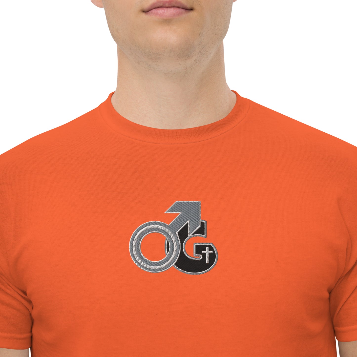 Front of orange t-shirt with black, gray and white embroidered symbol representing Man of God