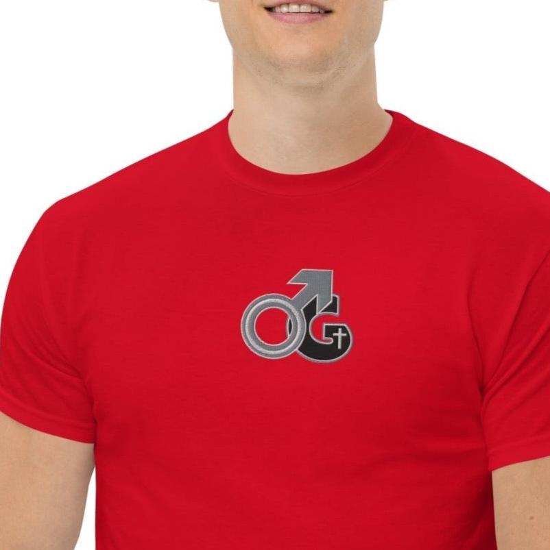 Front of red t-shirt with black, gray and white embroidered symbol representing Man of God