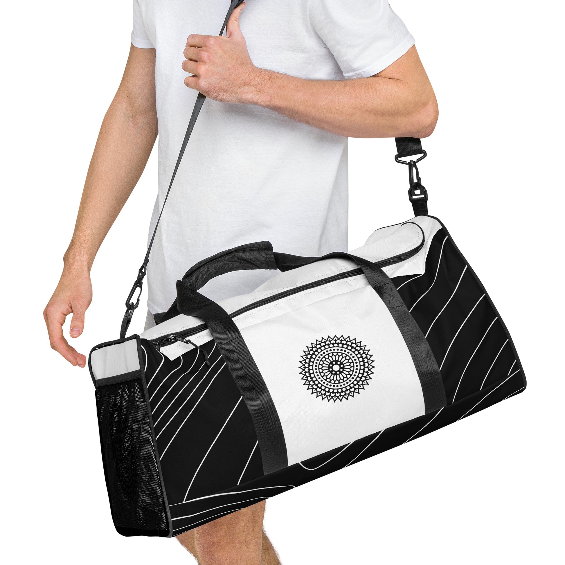 Right front of black and white print duffle bag with black mandala being carried by male