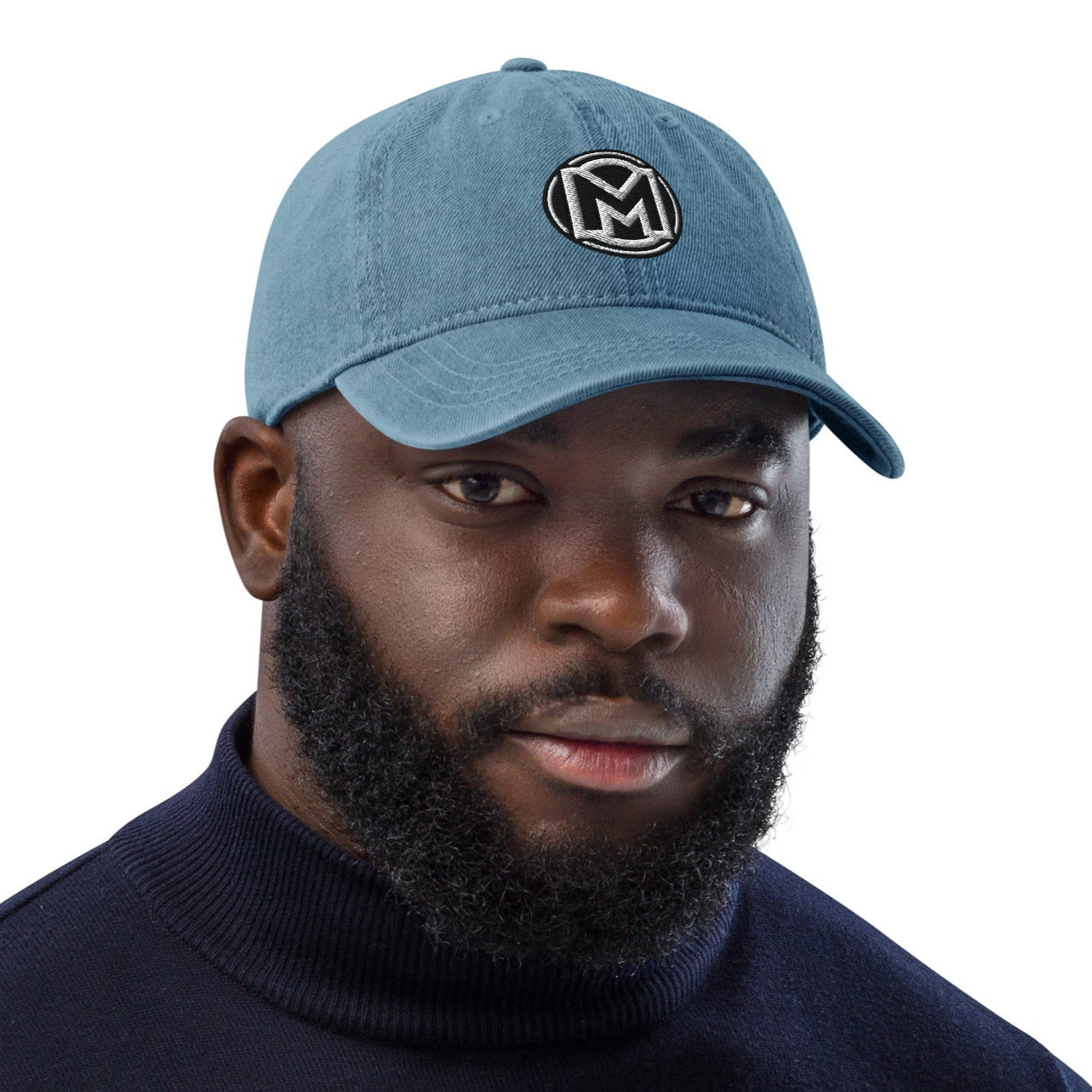 Front of blue cotton hat with manly 'M' embroidered across the front