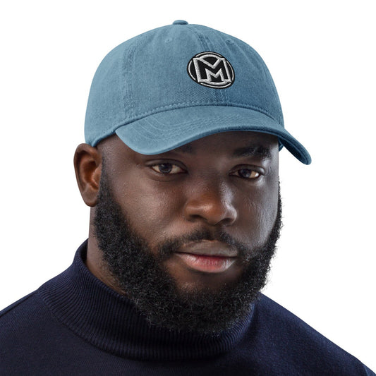 Front of blue cotton hat with manly 'M' embroidered across the front
