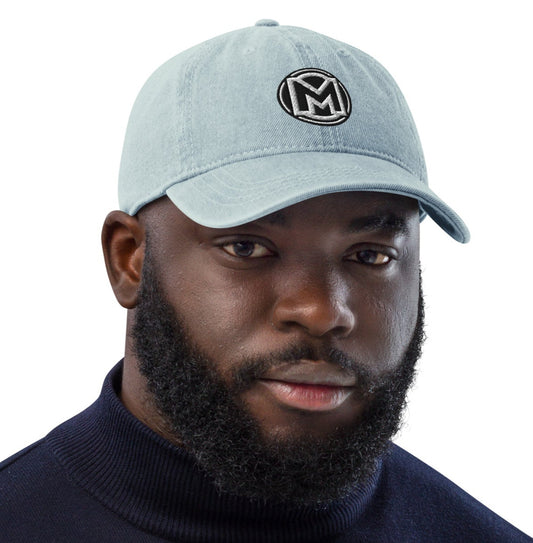 Front of light blue cotton hat with manly 'M' embroidered across the front