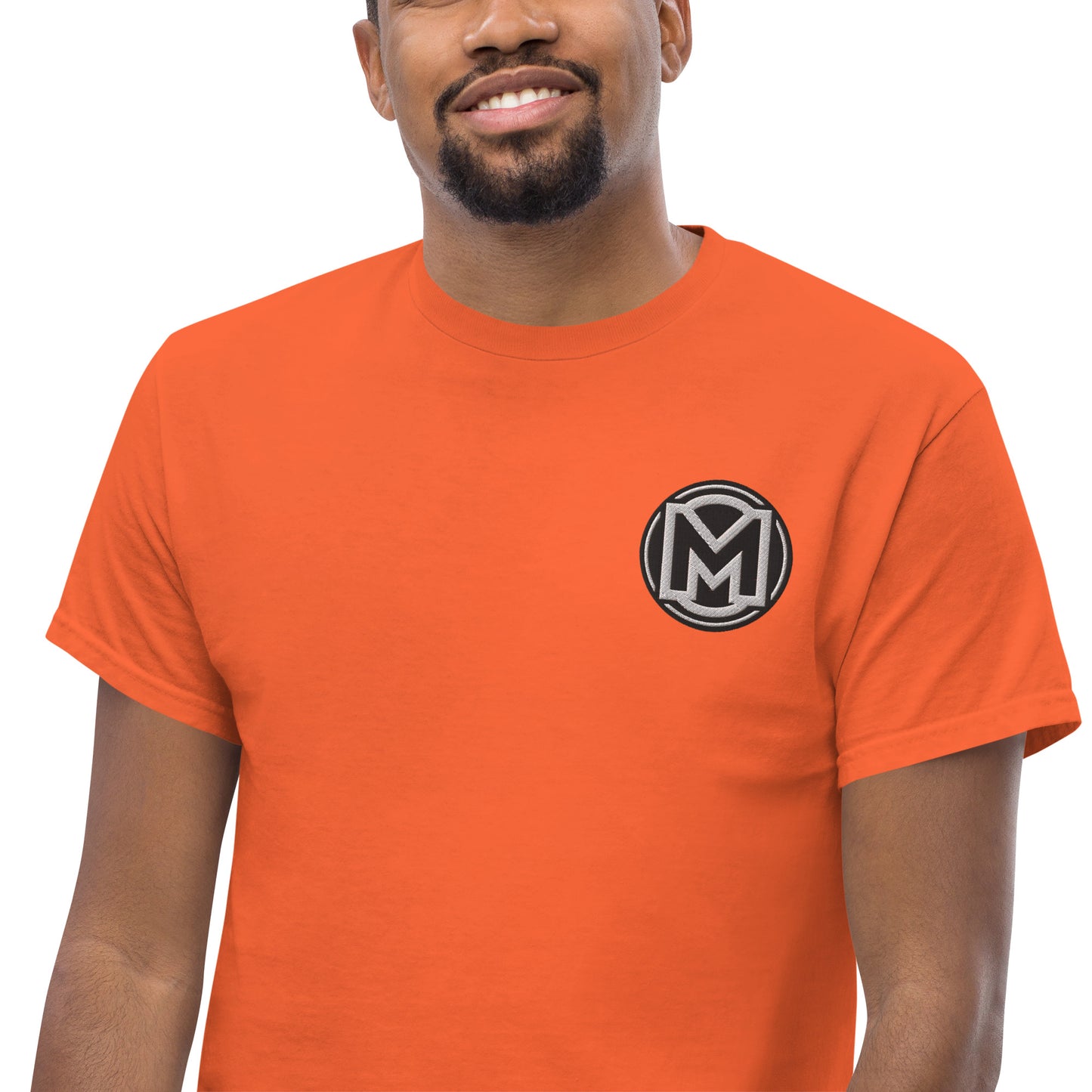 Front of orange Manly t-shirt with M logo on left chest