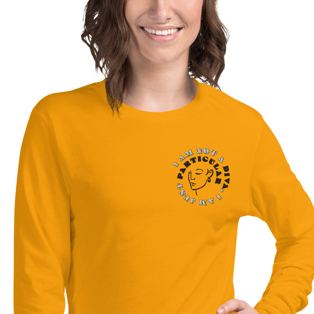 Front zoomed of gold long sleeved t-shirt with image of woman's face and text saying 'I am not a diva, I am just particular'