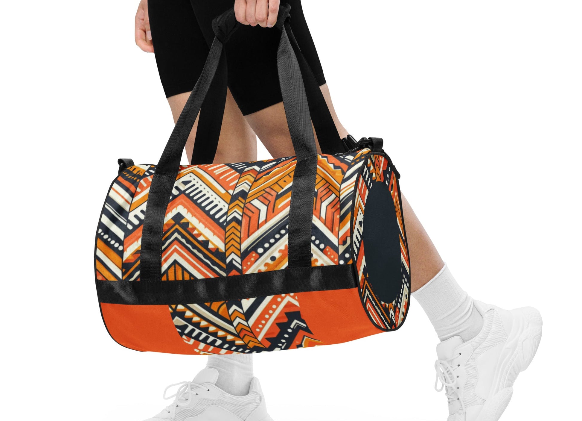 Front of orange and navy Aztec print gym bag being carried by female
