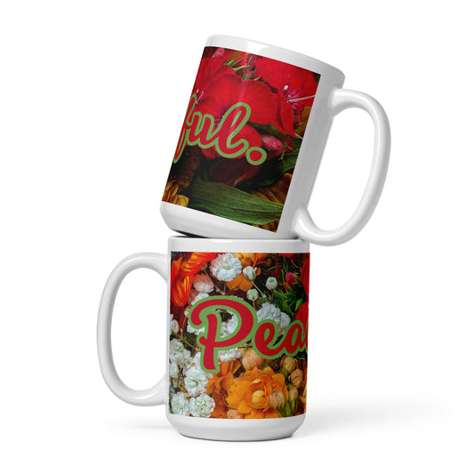 Two views of the mug, top mug is right view, end of text saying 'peaceful', bottom mug is left view, start view of text saying 'peaceful' on a pink gold, orange and white flowered background