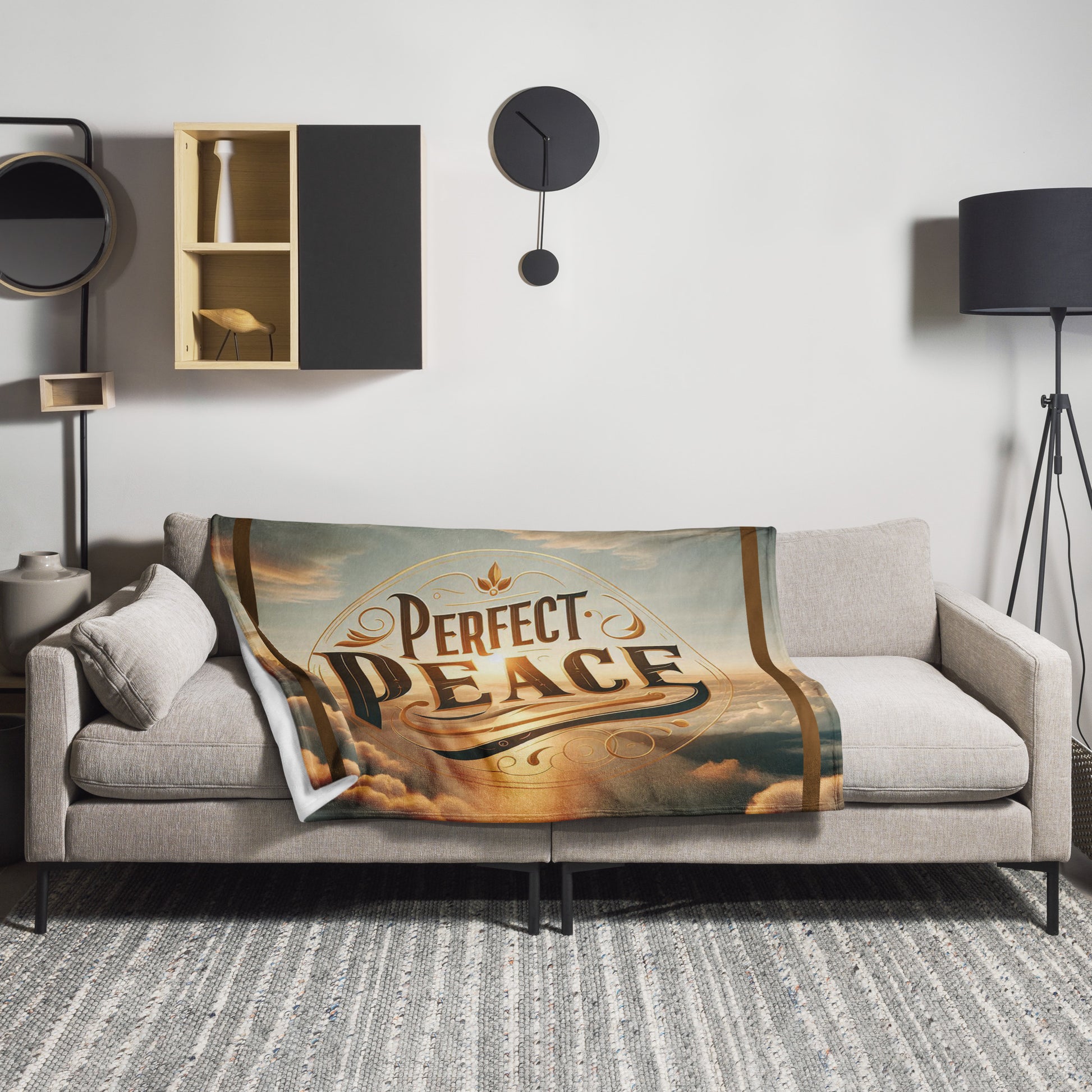 Front of 50x60 throw blanket laying on a couch with image of sky in blue and tans and word saying 'perfect peace' in brown