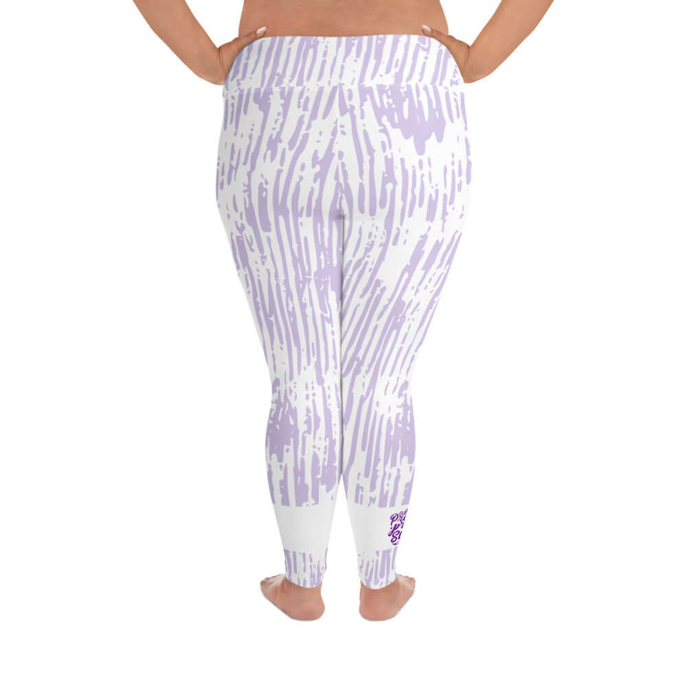 Back view of purple and white print leggings with purple text around bottom right leg saying 'Praise Pray Slay'