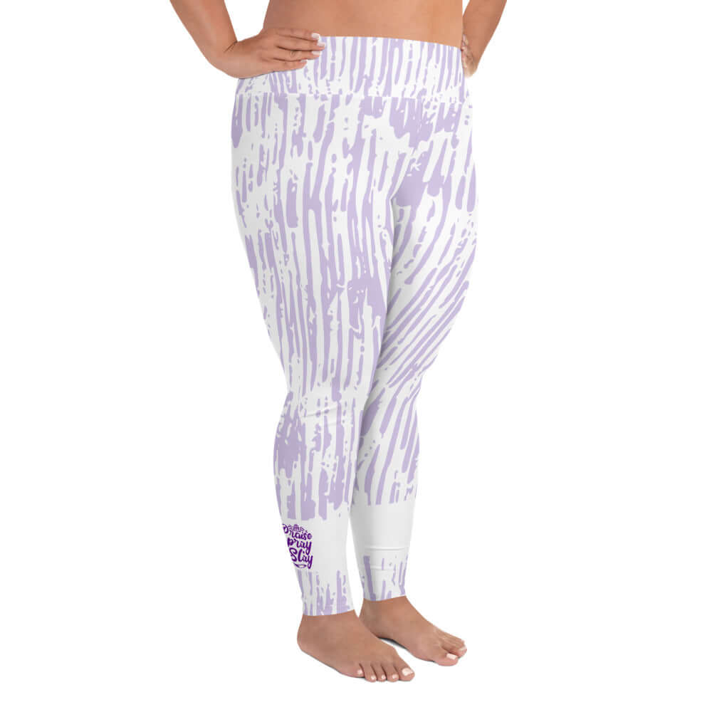 Right front view of purple and white print leggings with purple text around bottom right leg saying 'Praise Pray Slay'