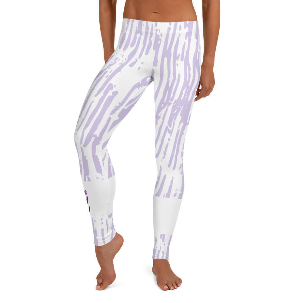 Front view of purple and white print leggings with purple text around bottom right leg saying 'Praise Pray Slay'