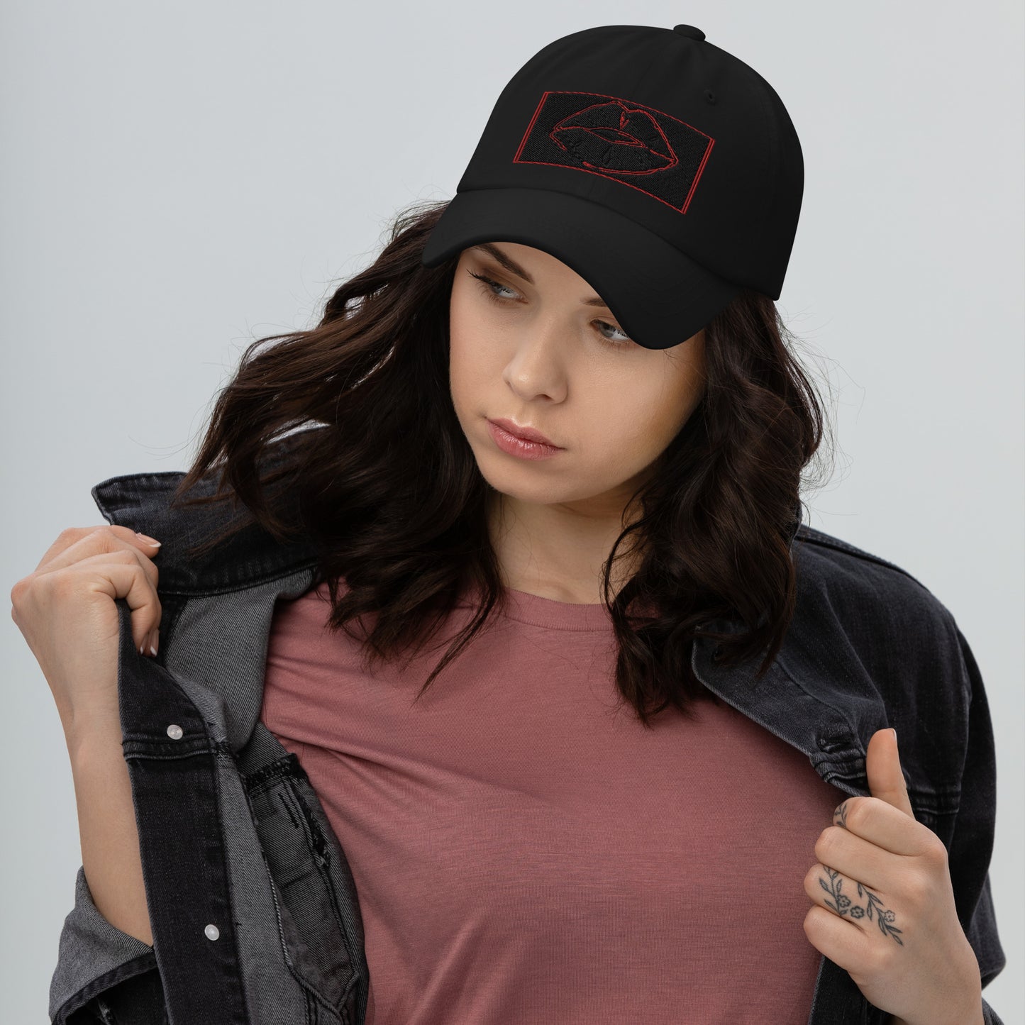 Front of black cap with red and black image of lips on front