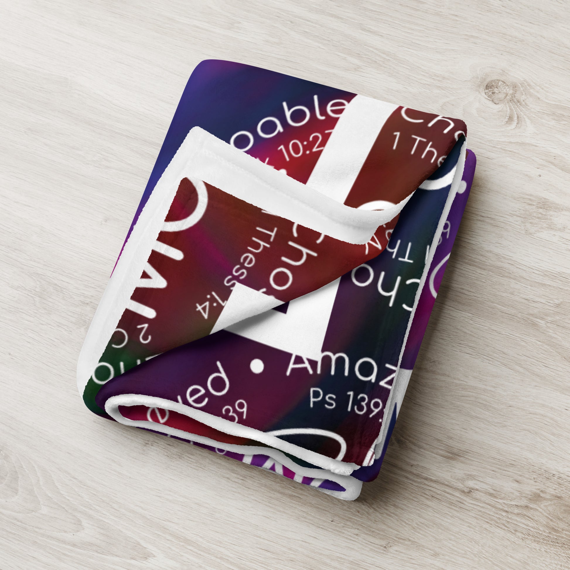 Throw blanket 50x60 with message 'She is Mom" in purple folded tight