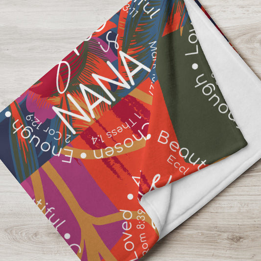 Throw blanket 50x60 with message 'She is Nana" in orange and green multi folded