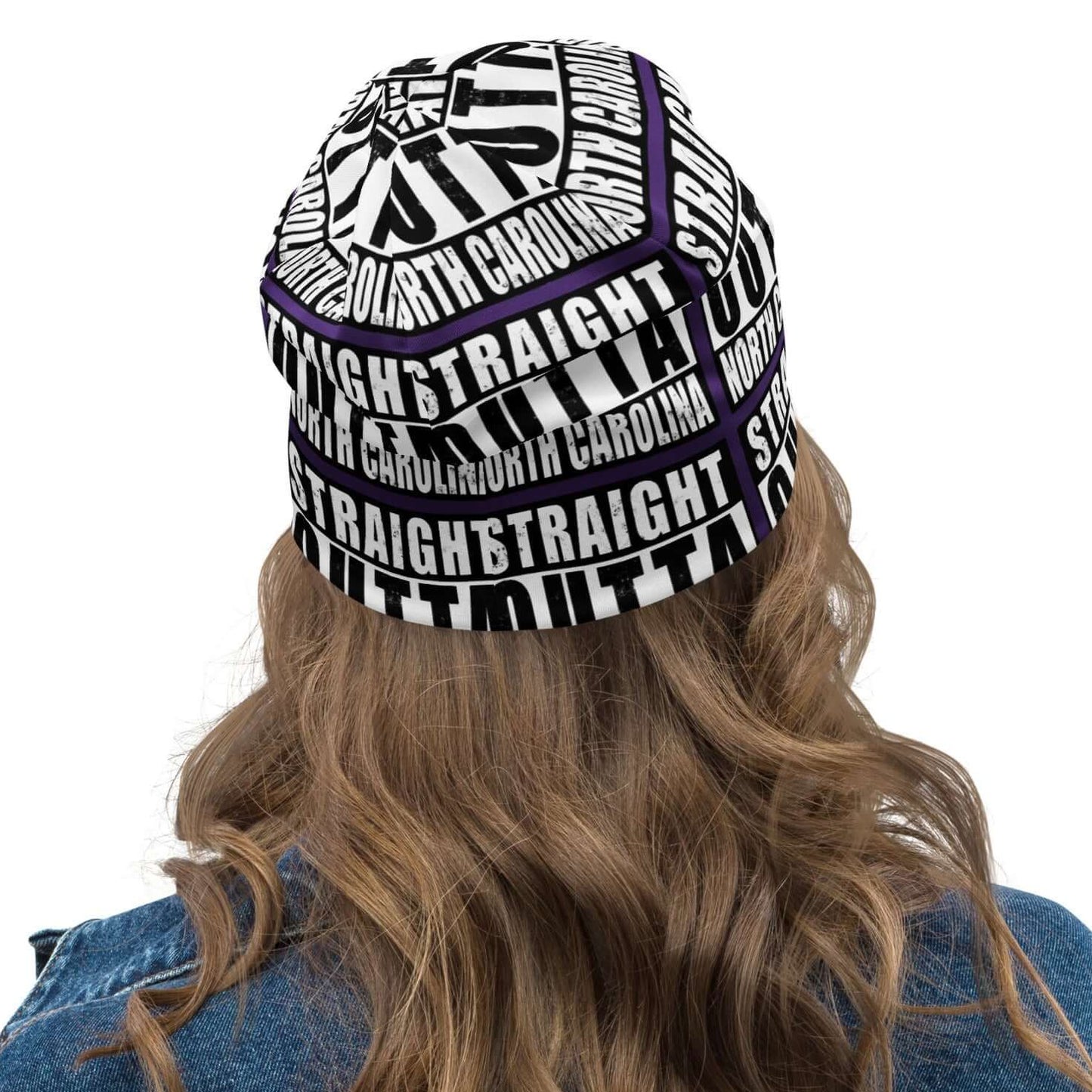 Back view of all-over-print unisex purple black and white beanie with message saying "Straight Outta North Carolina' 