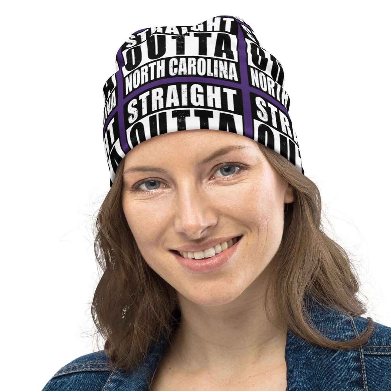 Front view of all-over-print unisex purple black and white beanie with message saying "Straight Outta North Carolina' 