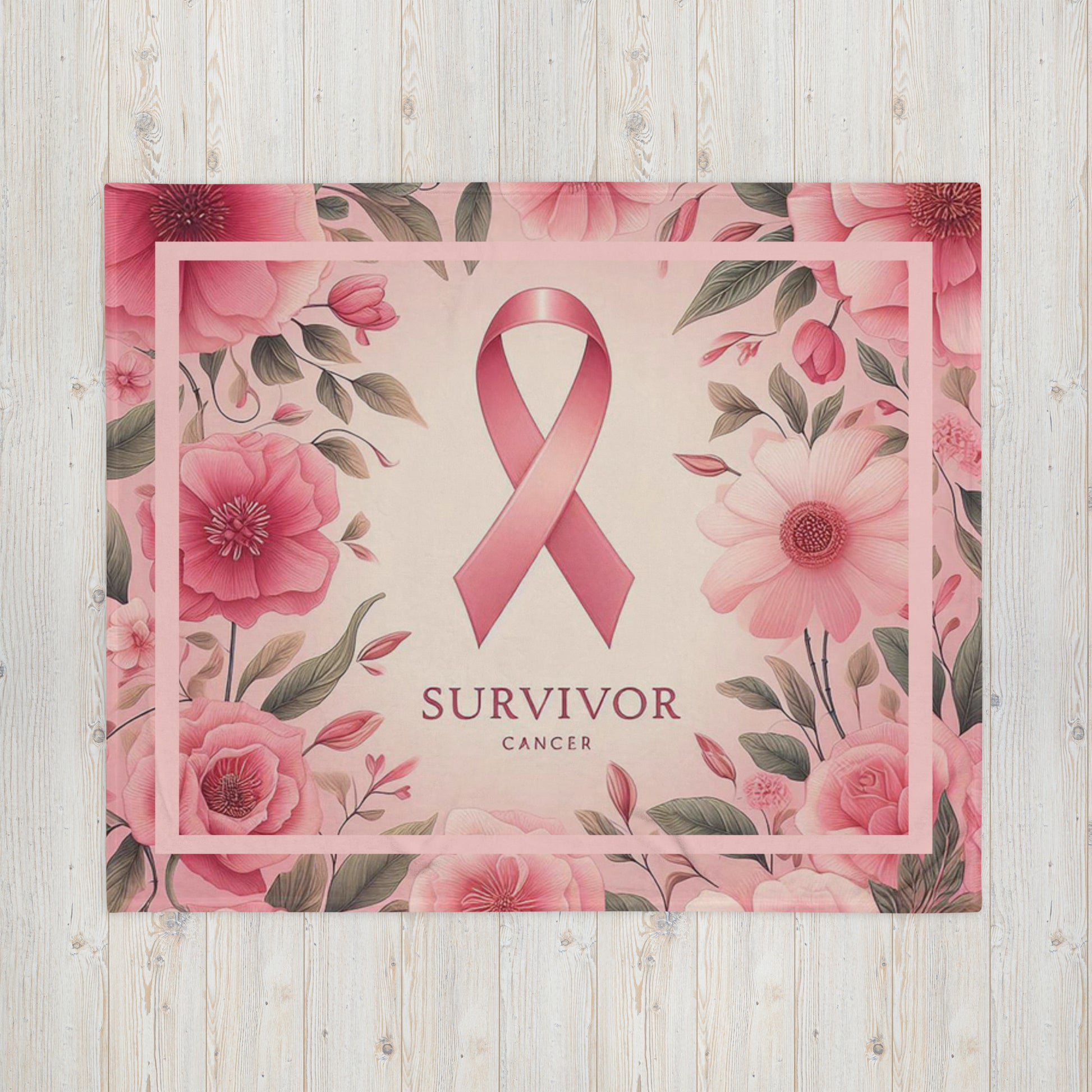 Front Survivor floral pink 50 x 60 throw blanket lying flat with image of pink flowers w/green leaves, pink ribbon, and words 'survivor cancer' beneath ribbon