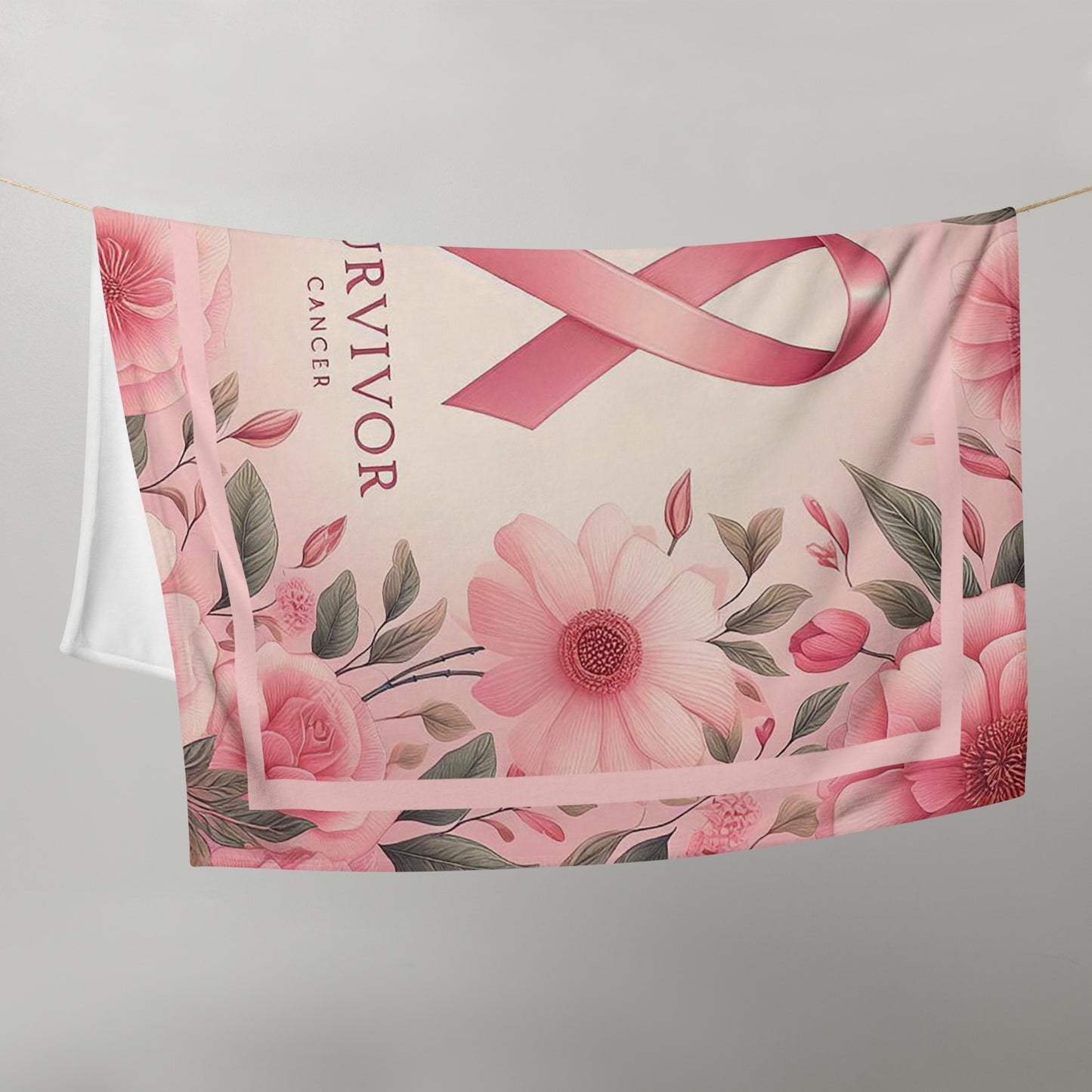 Survivor floral pink 50 x 60 throw blanket hung on back a cloths line with image of pink flowers w/green leaves, pink ribbon, and words 'survivor cancer' beneath ribbon
