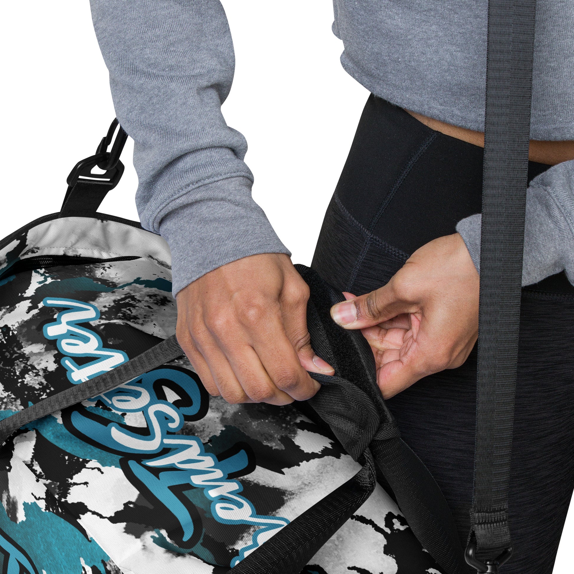 Details of Black, white and blue stripped and patterned duffel with 'TS' text and 'TrendSetter' text