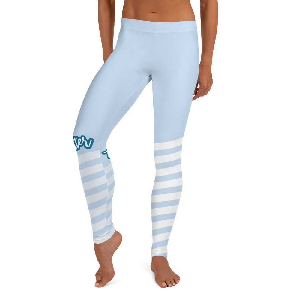 Front view of leggings with light blue on the top and light blue and white strips at the bottom, text saying "trendsetter' is across the right knew