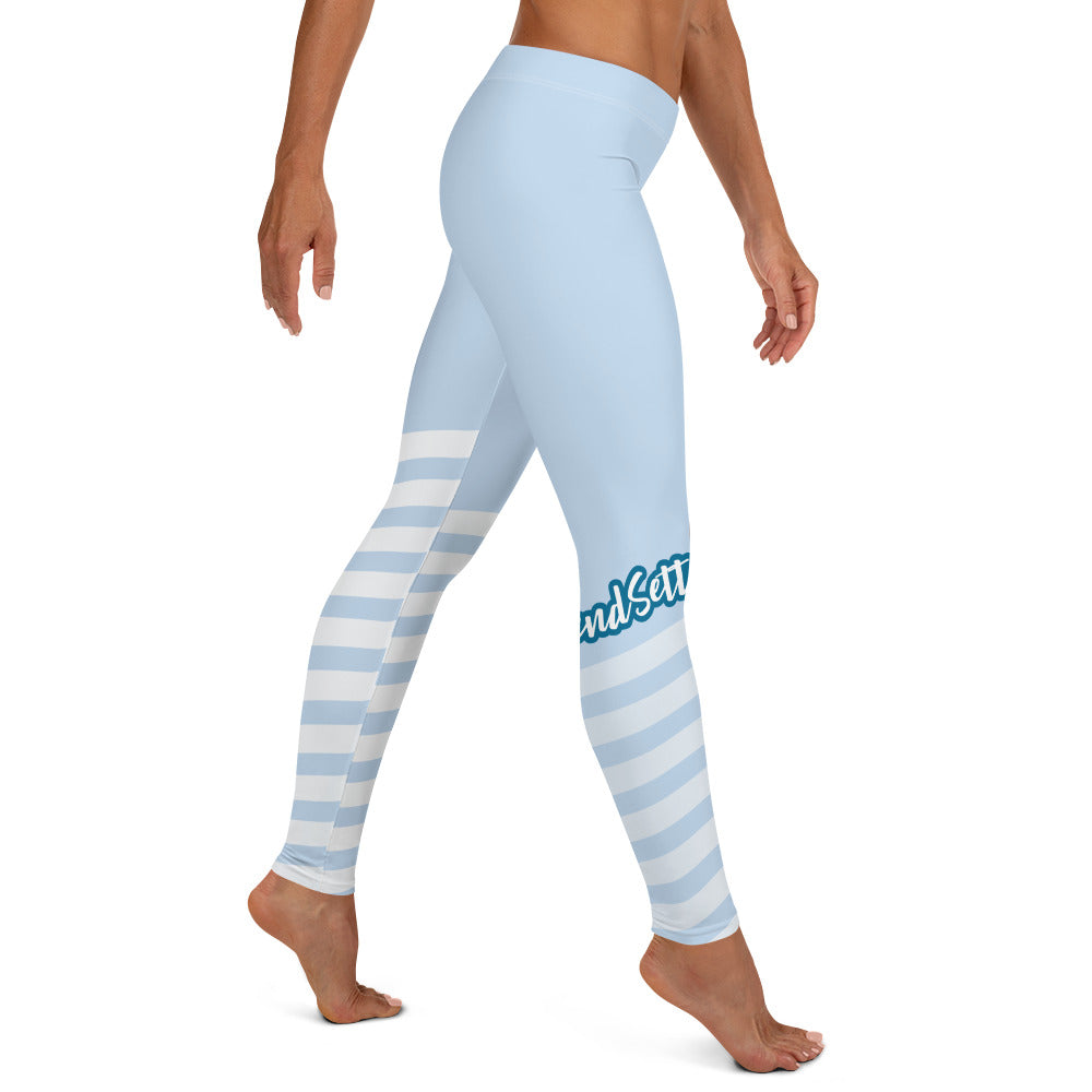 Right view of leggings with light blue on the top and light blue and white strips at the bottom, text saying "trendsetter' is across the right knew