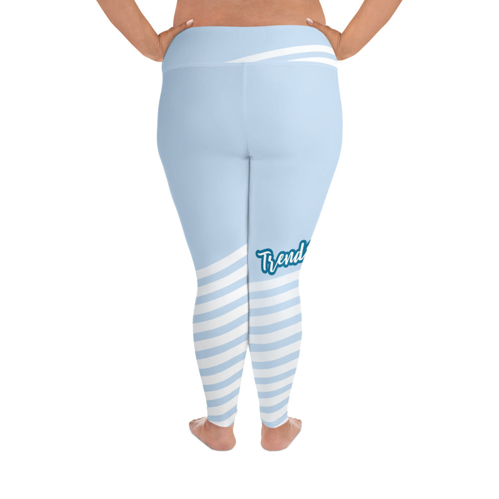 Back view of leggings with light blue on the top and light blue and white strips at the bottom, text saying "trendsetter' is across the right knee