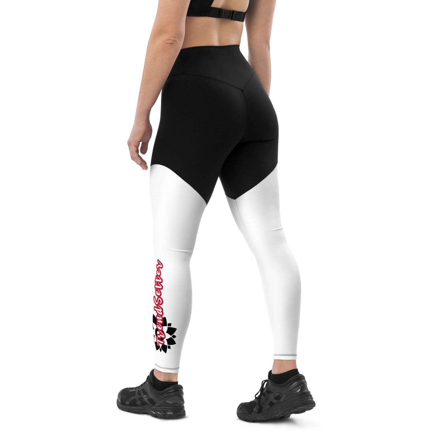 Back left of black and white legging with vertical black and white design with text saying 'TrendSetter' on left calf