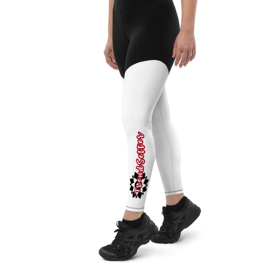 Left of black and white legging with vertical black and white design with text saying 'TrendSetter' on left calf