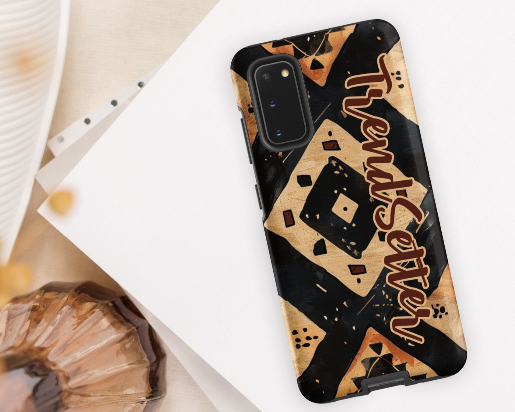 Front of TrendSetter Mother Land Roads 20 Samsung mobile cover with black and beige pattern with brown text saying 'TrendSetter'