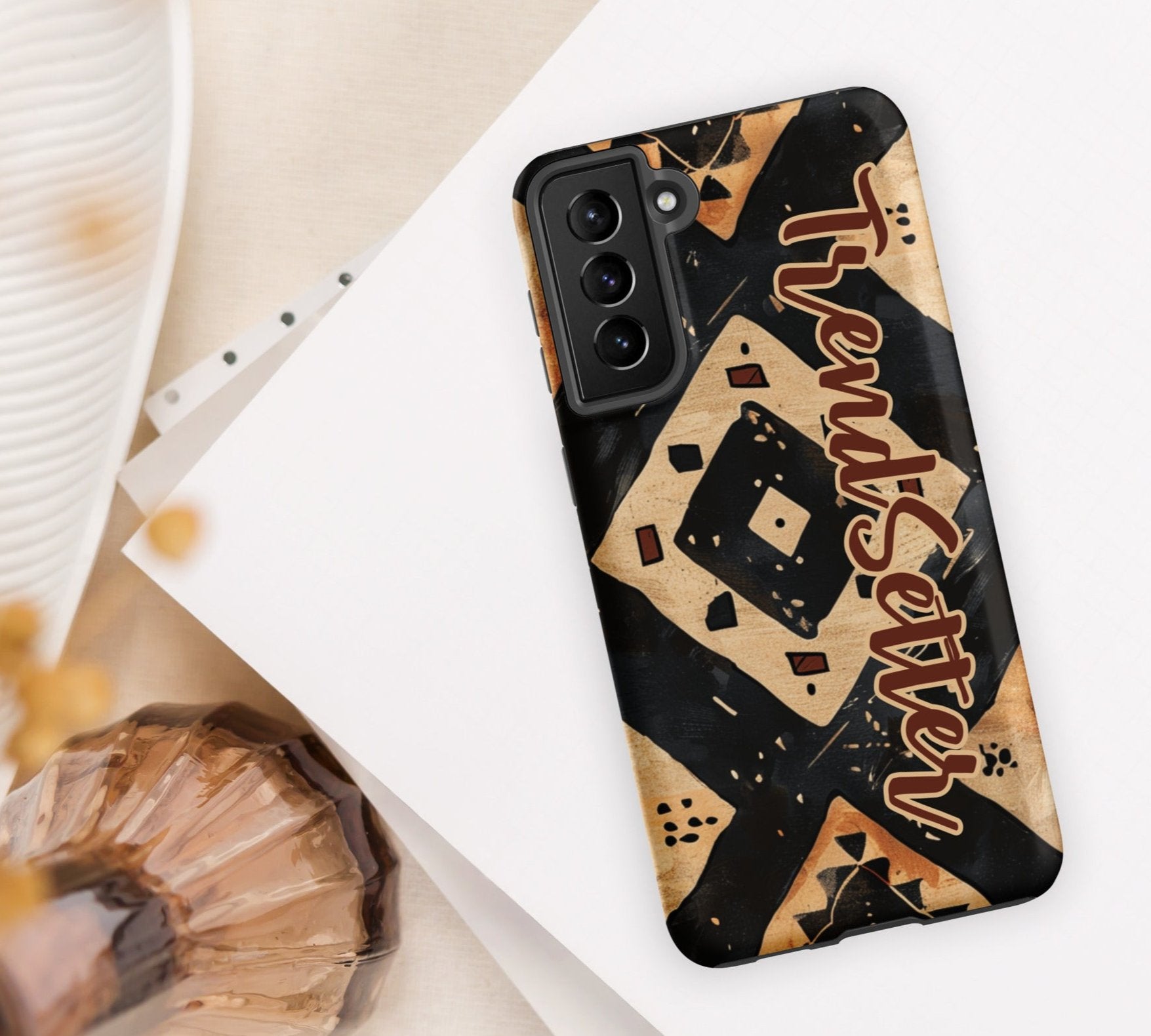 Front of TrendSetter Mother Land Roads 21 Samsung mobile cover with black and beige pattern with brown text saying 'TrendSetter'